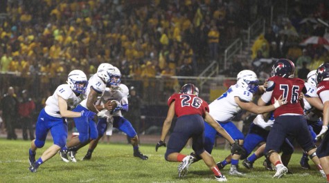 Varsity Football players Dominic Labellarte ('16) and Malik Turner ('16) jump into action at the start of a play. 