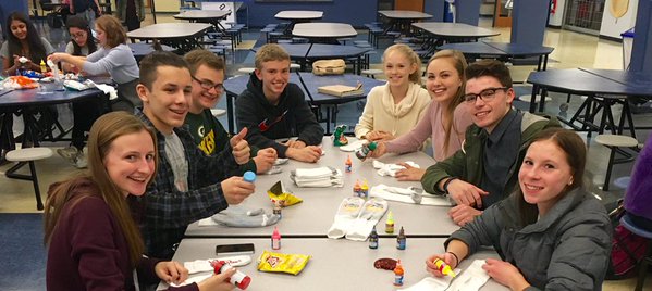 (From left to right) Megan Rittler (‘17), Brooks Walls (‘18), Ryan Bohr (‘17), Jacob Wetjen (‘17), Kimberly Wetjen (‘19), Danielle Thomsen (‘19),  Josh Cook (‘18), and Agathe Olier (‘17) make unique skid-free socks for the Salvation Army.  