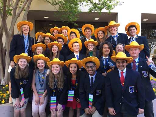 BC DECA students pose for a picture wearing their Wisconsin cheese hats to represent Wisconsin. DECA members could trade their state souvenirs with members from other countries.