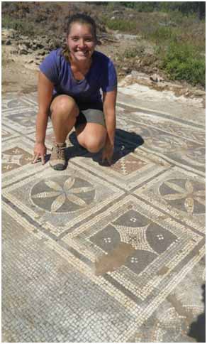 Elizabeth Bews is pictured above posing with a mosaic that her research team in Southern Turkey discovered. This artifact is one of the largest mosaics ever found in Turkey.