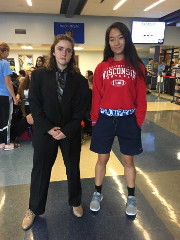 Senior Katie Rossman (left) dresses head-to-toe in a men's suit. Senior Livia Shi (right) borrowed some basketball shoes and navy khaki shorts. 