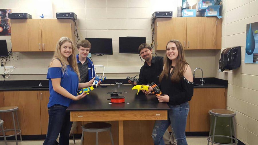 BC’s 3D printing club poses and holds up the prosthetic appendages, excited for the upcoming year. From left to right: Alexa Keane (‘17) Gage Gosset (‘17), Mr. John Wilkinson, Amy Keane (‘19). The club is an opportunity for students to explore biomedical engineering.