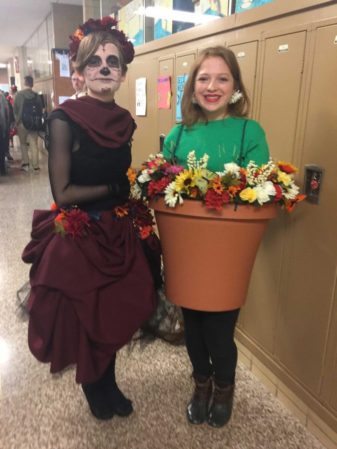 Seniors Rae Davel (left) and Sophie Bohr (right) pose in their unique Halloween costumes. Rae is dressed as a sugar skull. Sophie is dressed as a flower pot.
