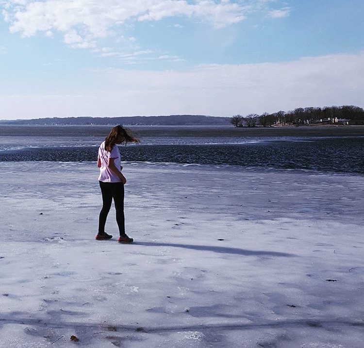 Madison Hummel (‘17) stands on a frozen Pewaukee lake, embodying the “free senior spirit”.