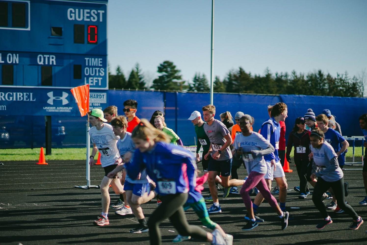 A group of runners begin the race on the track at the BCHS football field.