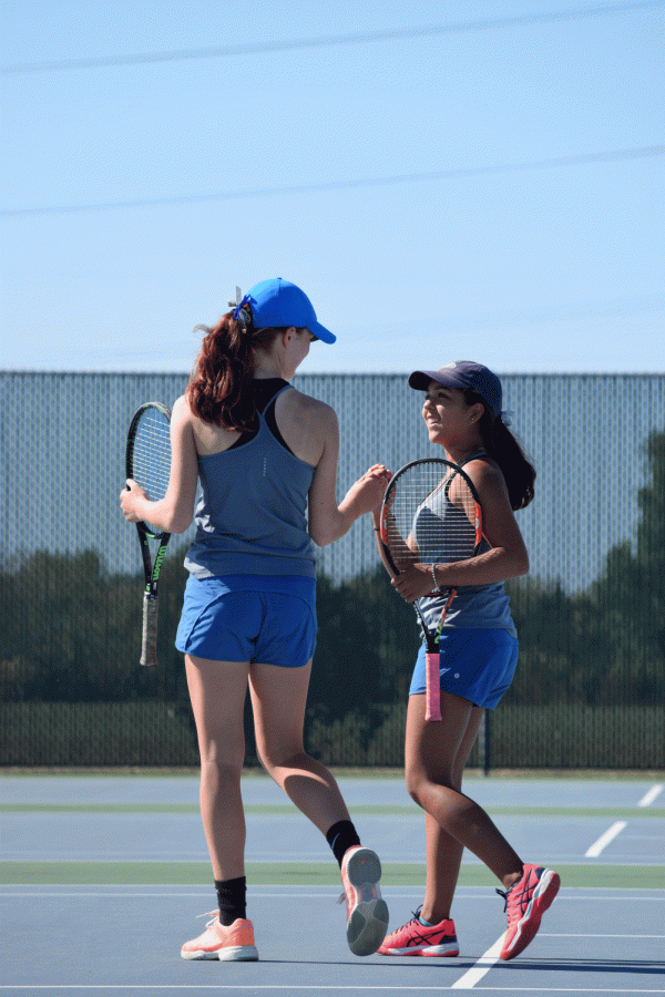 Doubles+partners+Lizzie+Peterson+%28%E2%80%9818%29+and+Elianne+del+Campo+%28%E2%80%9820%29+fist+bump+each+other+after+playing+out+a+good+point.