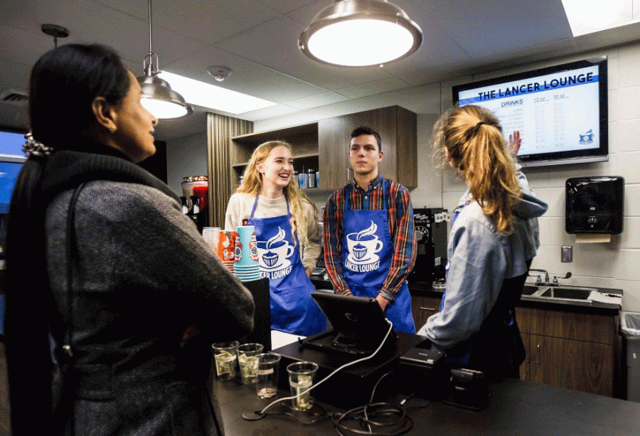 Chelsea Russell (‘18), Sam Shibilski (‘18), and Cami Herman (‘18) assist a customer in the newly opened Lancer Lounge. As members of the Business Management class, theses three seniors help manage the Lancer Lounge while gaining experience in what it means to run a business.