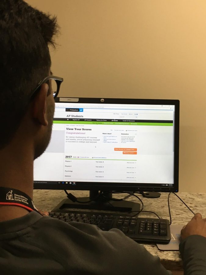  Abhinav Mahesh( 19) looking up his AP scores online