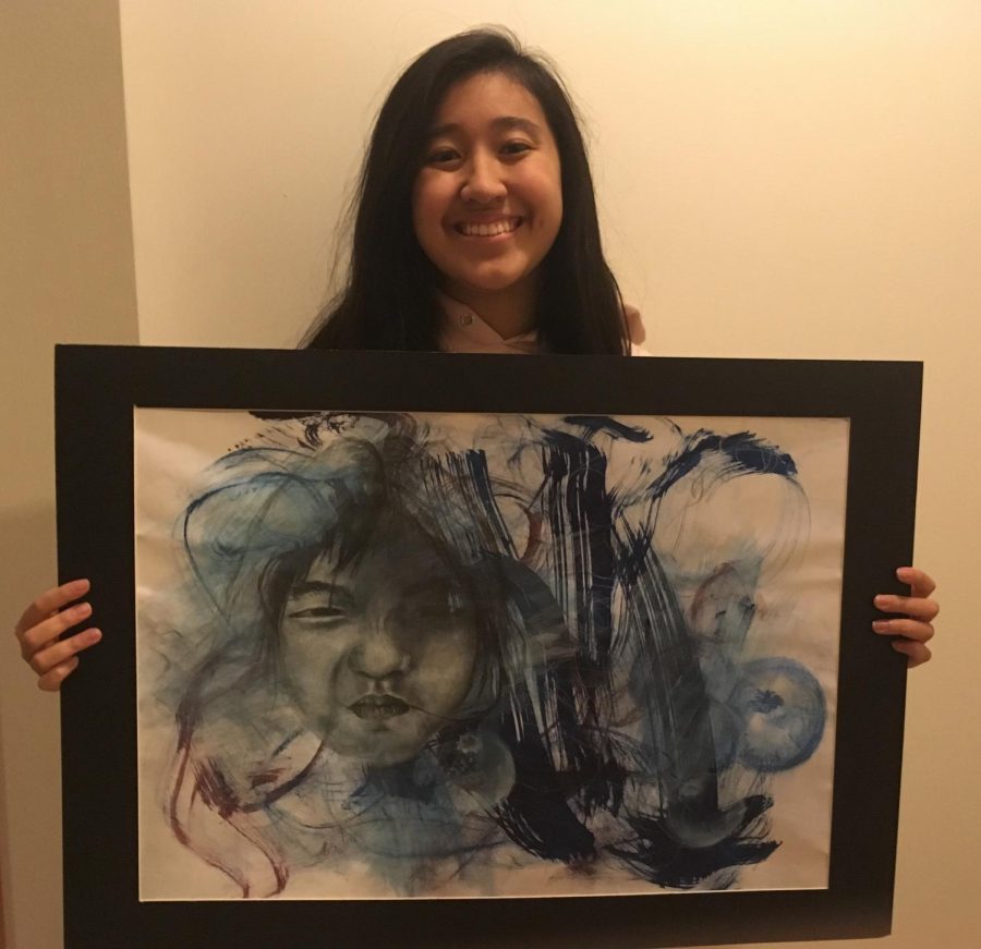 Laurel Chen (18) shows her winning artwork