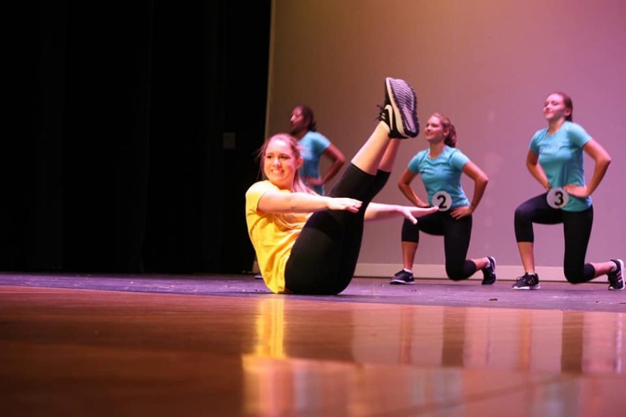 Keane (19) holds a v-up during her fitness routine at the state competition at the South Milwaukee performing Arts Center.