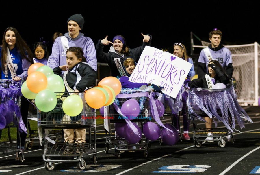 As a part of the traditional Homecoming parade, court members wheel shopping carts around the football field. Each Homecoming court pairing was given a shopping cart to decorate. From left to right: Tallulah Nummerdor, Hana Li, Kevin Jacobson, Megan Kiese, Mary Ellen Ritter, Mark Nemcek, Brooke Barreda, Pierce Boldin, Kelsey Bennett. 