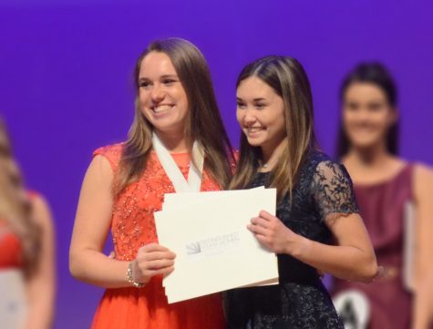 The 2019 Distinguished Young Woman of Wisconsin, BCHS alumn Amy Keane
(‘19), presents Riley Feng (‘20) with the title of 2020 Distinguished Young Woman
of Wisconsin. Feng will be competiting again in June. “I loved state week so getting
to go to nationals will be super fun,” said Feng.