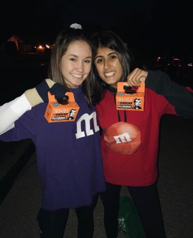 Riley Feng (210) and Nisha Desai (21) smile with their filled donation boxes after last years Trick-or-Treat for UNICEF. It is such a fun way to collect money for a great cause. said Feng. Key Clubbers love being able to dress up all while helping prevent the spread of neonatal tetanus.