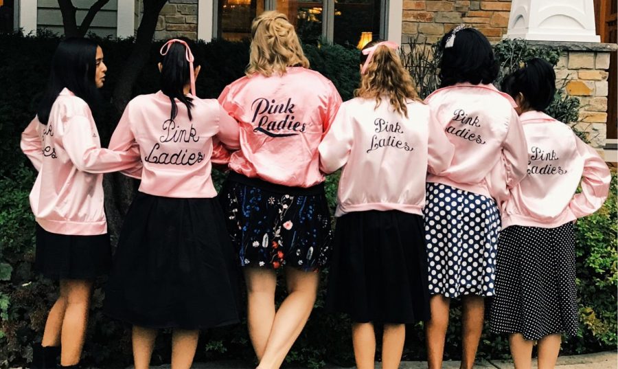 Junior girls don the iconic Pink Ladies jackets. Left to right: Lana Gharia, Vera Fong, Maggie LaRos, Allie Gosenheimer, Miriam Budithi, and Fuka Sunagawa