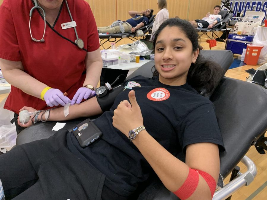 Trisha Nandakumar (‘21) gives a thumbs up while her blood is drawn. She reportedly fainted later on in her third block class. “I felt fine for a while and just forgot to drink water.

Then, I started feeling really thirsty during class and that’s when it happened. After fainting,
I just drank water and went back to class, and I felt fine. I didn’t realize that people were
freaked out about it until I talked to my friends later,” she said.